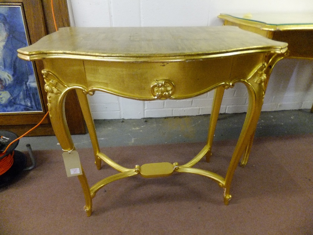 A late 19th century gilt wood table having frieze drawer resting on four carved shouldered