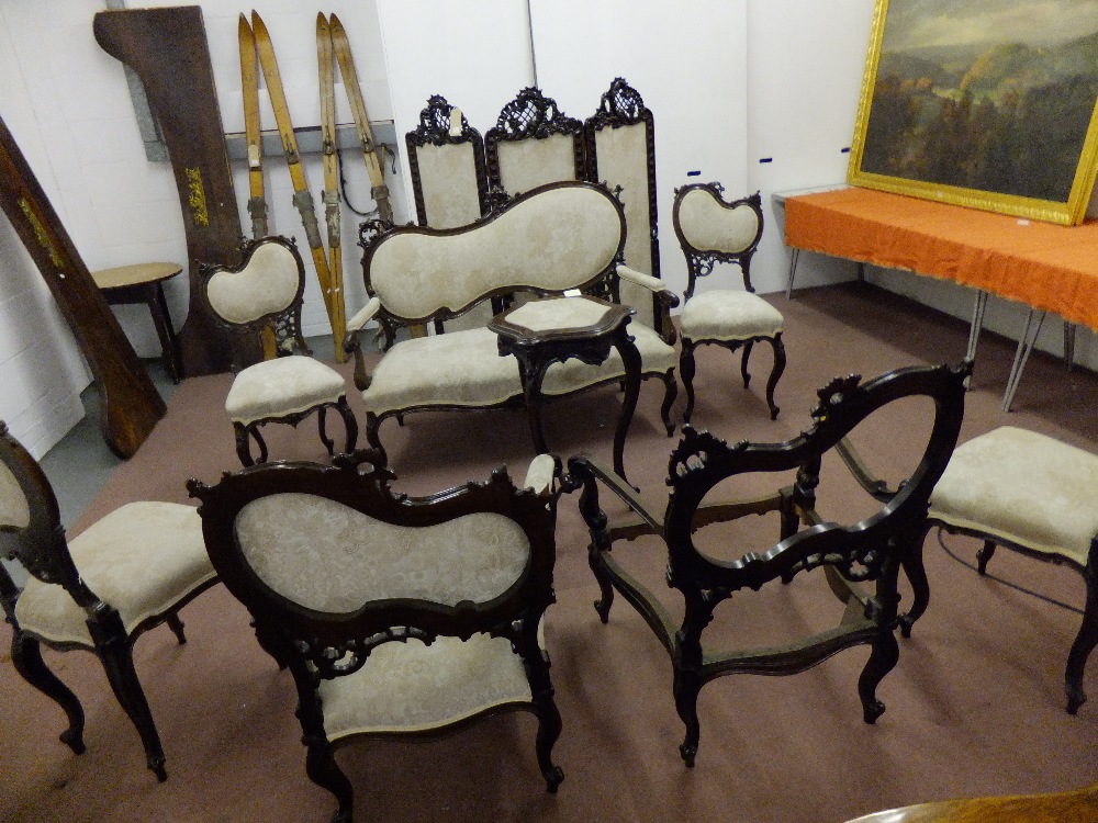 A circa 1870 rococo style carved wood suite with upholstered seats comprising three fold screen,