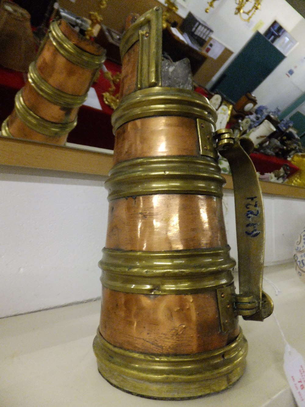 A late 19th century copper jug having four brass rings with hinged handle 32cm high