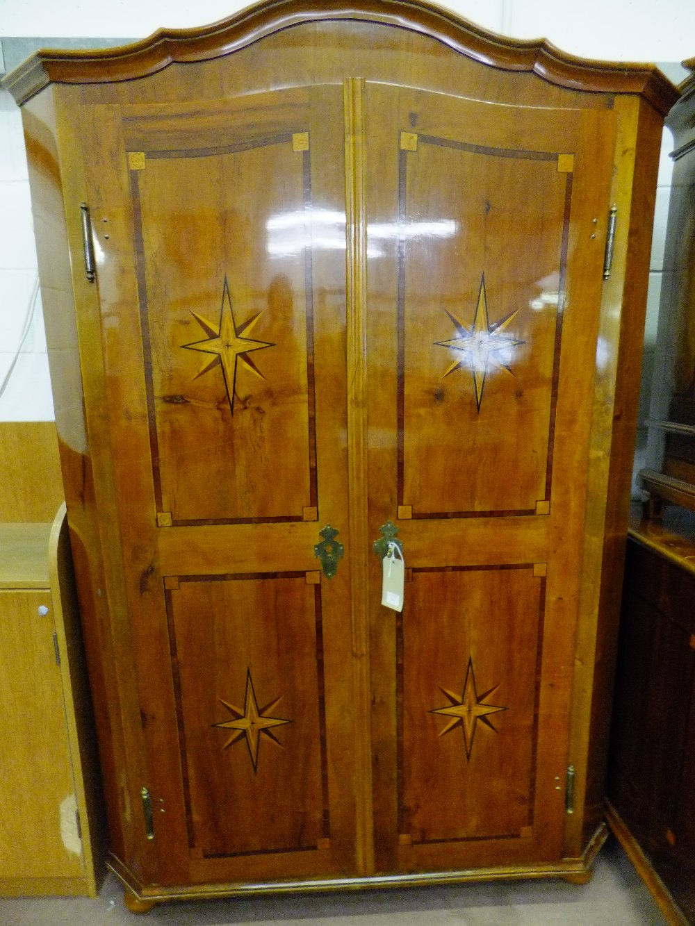 An early 19th century pentagonal wardrobe the softwood carcass inlaid with geometrical design the