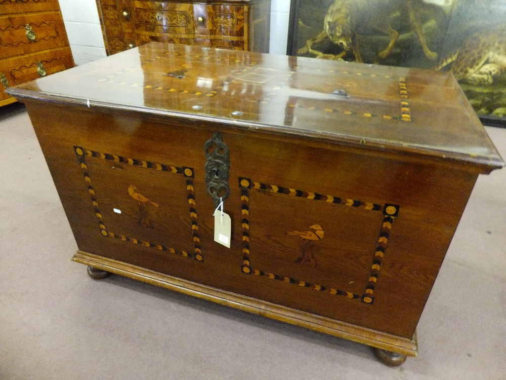 An early 19th century chest having checkered inlaid panels with bird decoration, with original