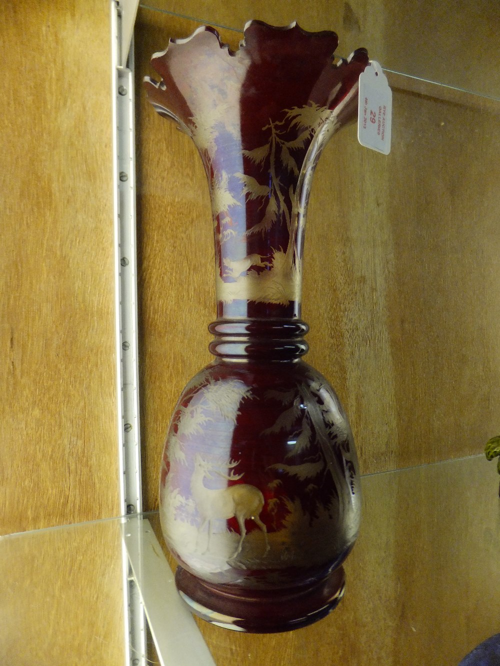 A mid 19th century Bohemian ruby flash glass vase having stag and forest decoration, the neck with