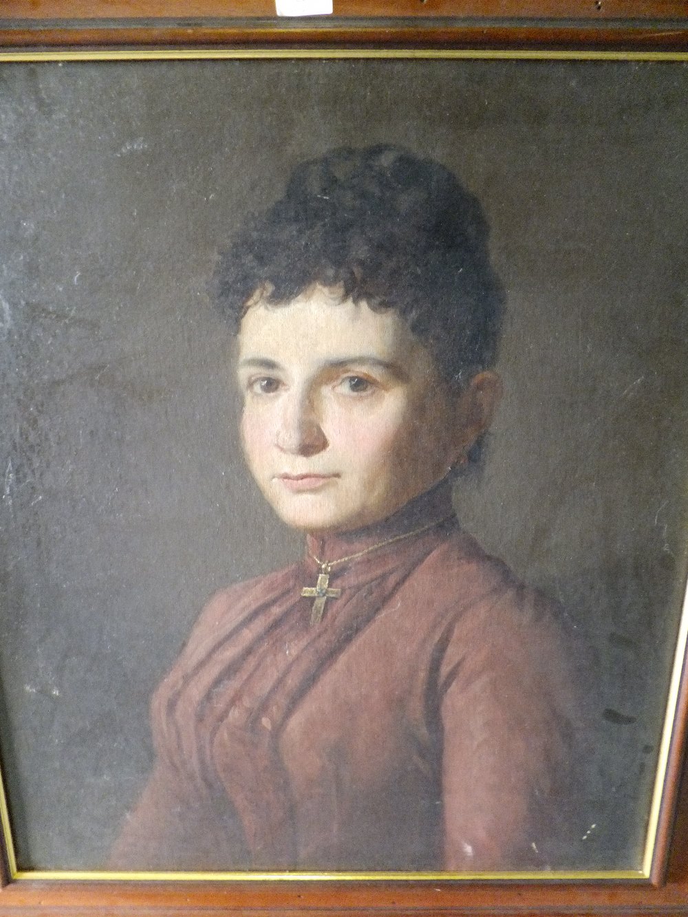 UNKNOWN ARTIST late 19thC oil on canvas portrait of a lady with a gold cross, unsigned, undated,