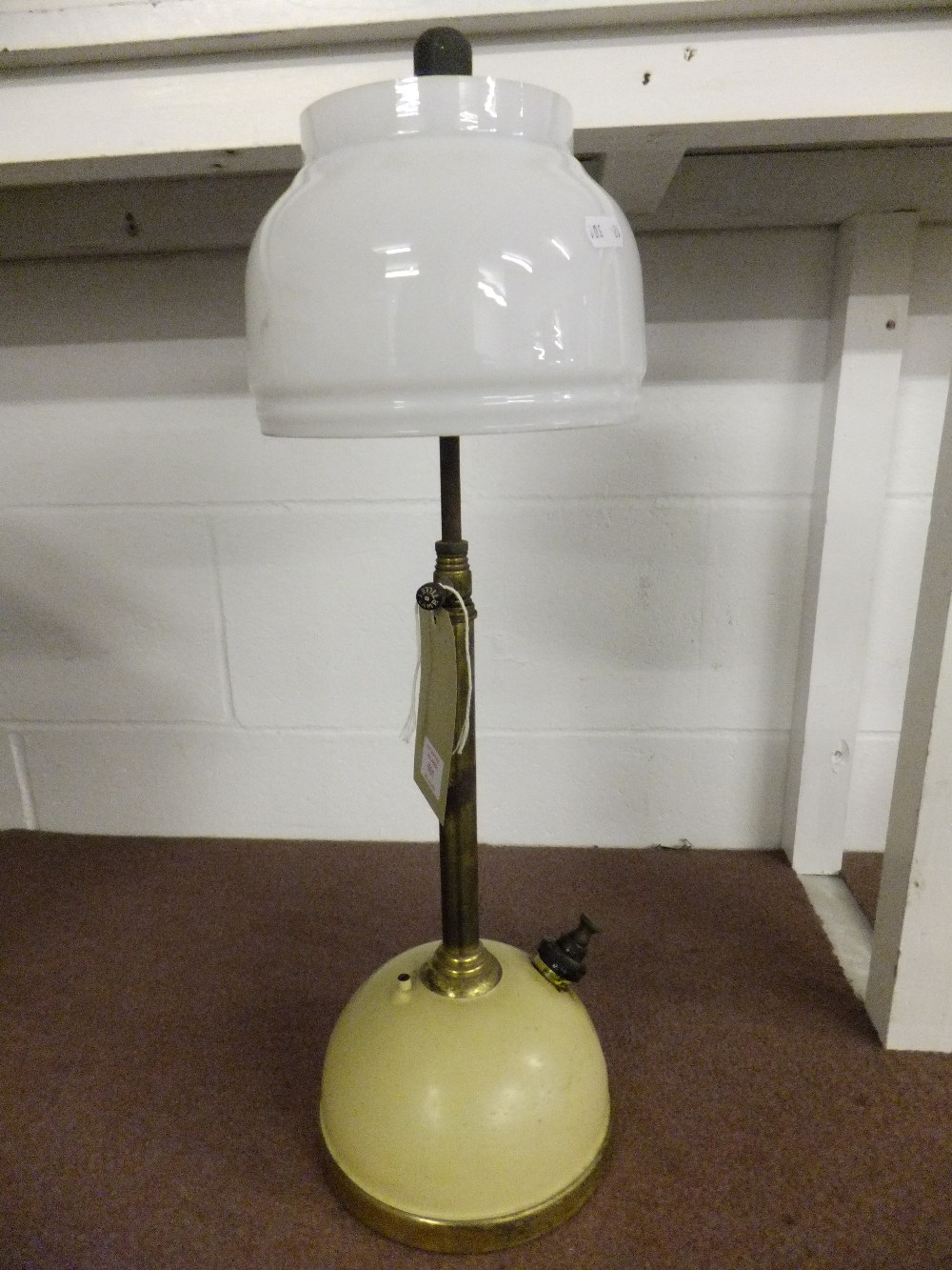 A vintage brass Tilley lamp with original shade