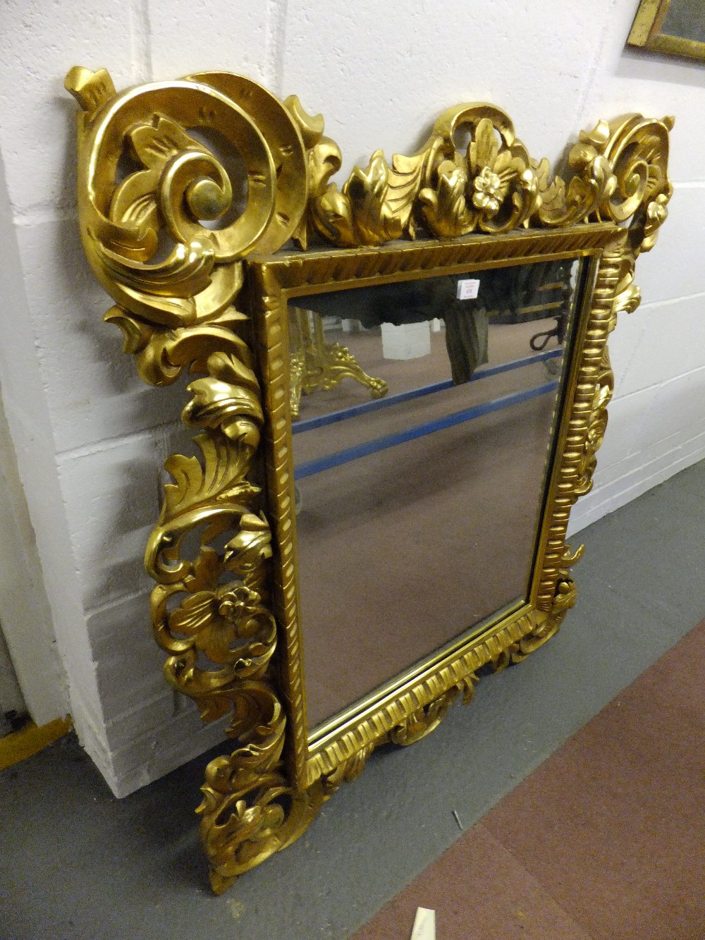 A mid-19th century gilt and carved Florentine mirror having ornate acanthus and scroll work to