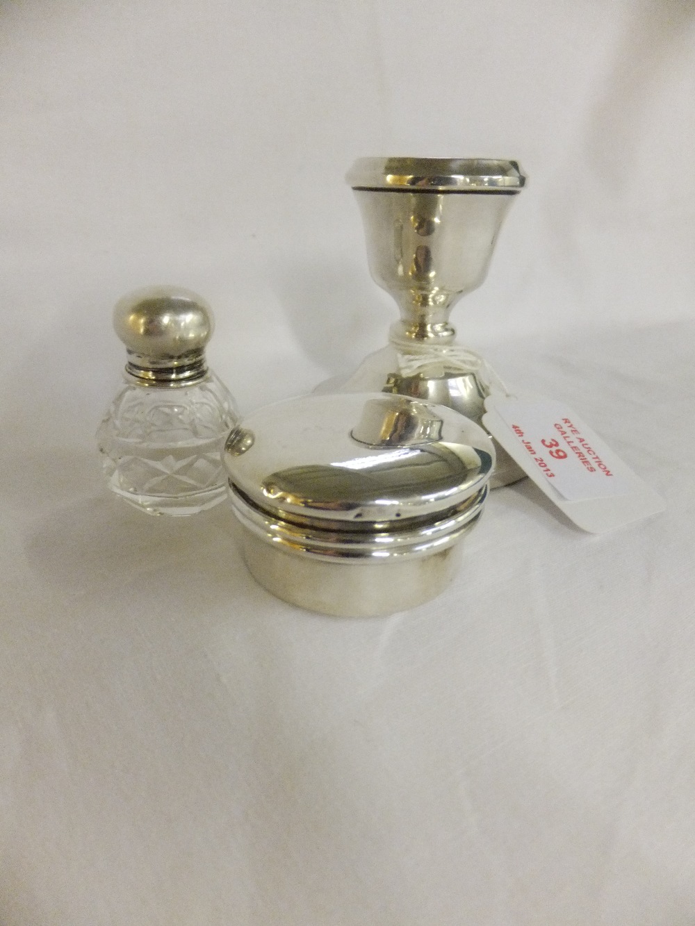 A Birmingham silver candlestick, Birmingham silver pill pot and small perfume bottle