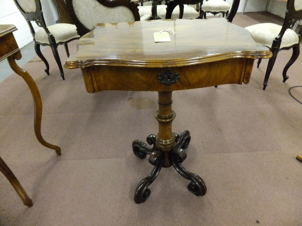 A circa 1860/70 walnut veneered sewing table having frieze drawer with inner compartments on a