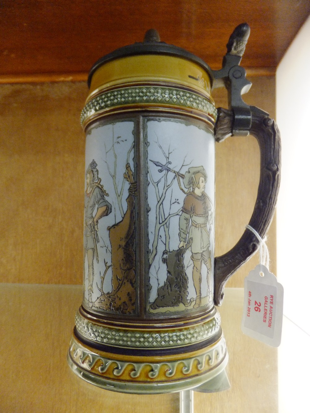 A Mettlach stein having hinged pewter lid with tree bark handle, four pictorial hunting scenes