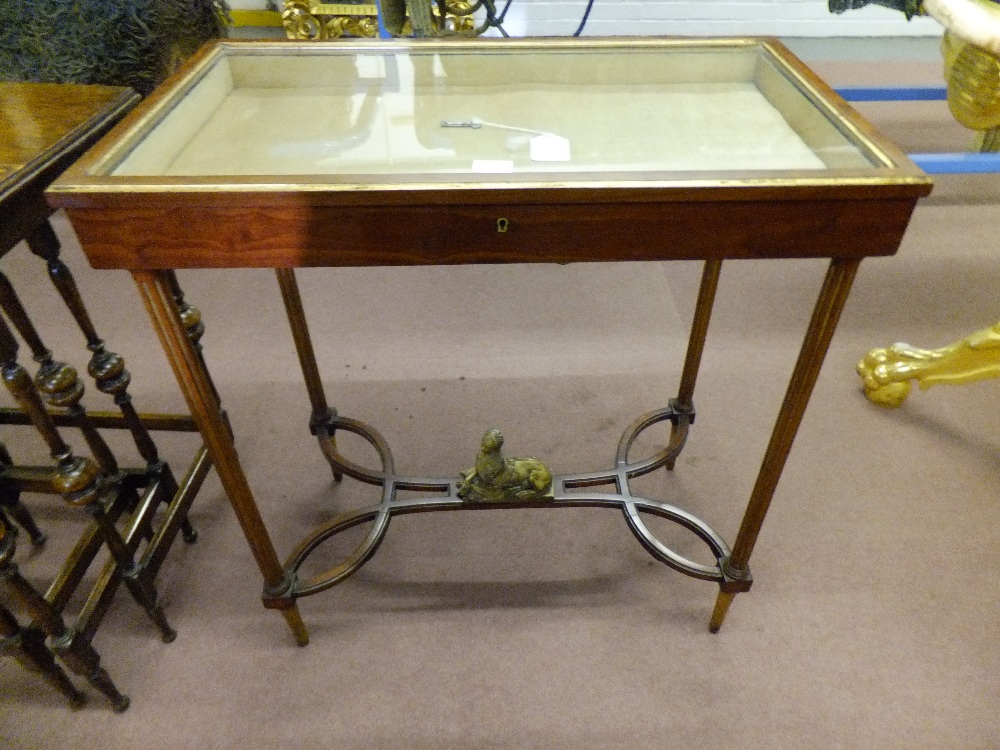 A Regency mahogany vitrine having turned fluted supports with sphinx figure on shaped stretcher