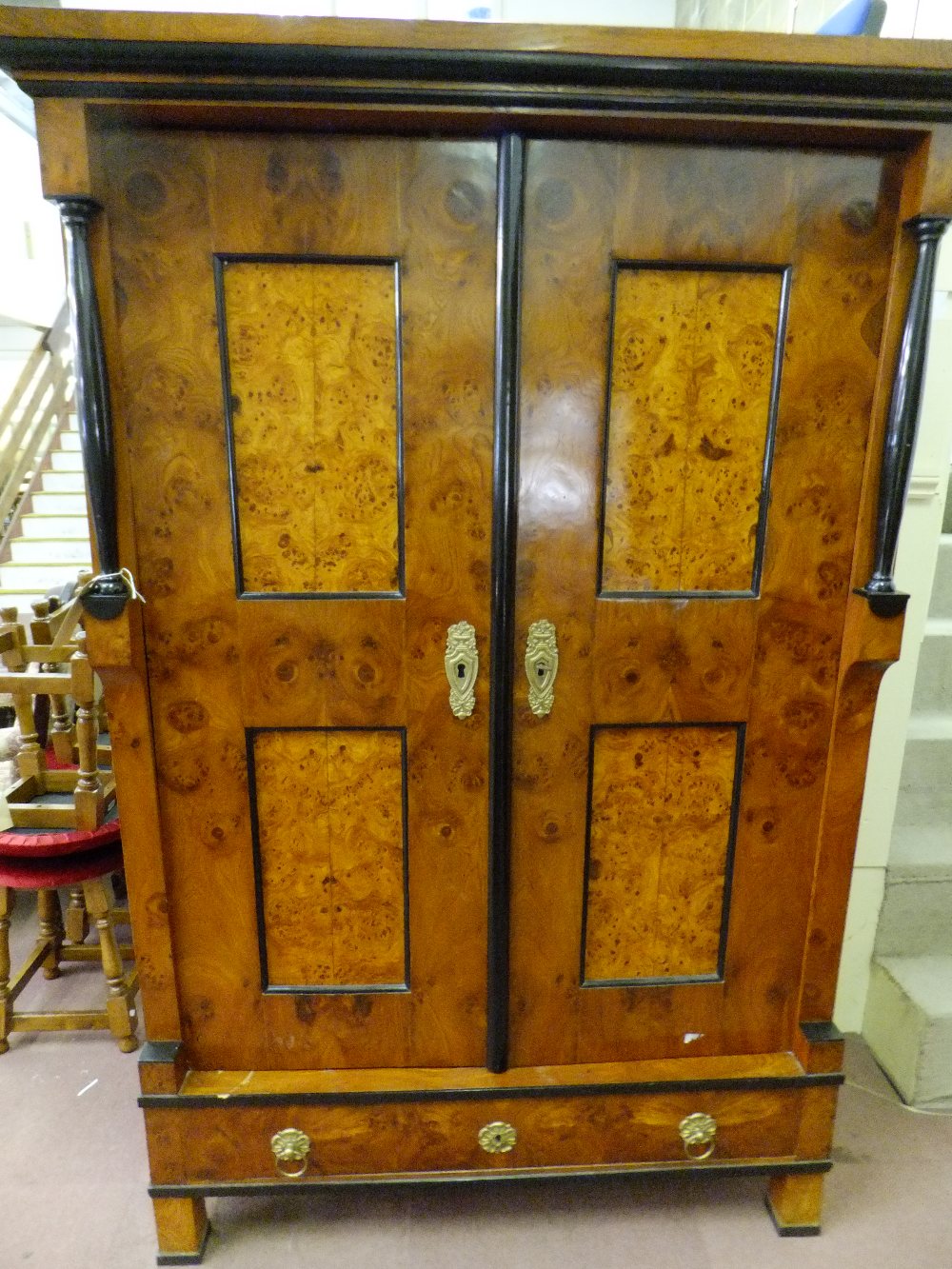 A circa 1830's Beidermeier veneered two door wardrobe the double doors enclosing hanging space