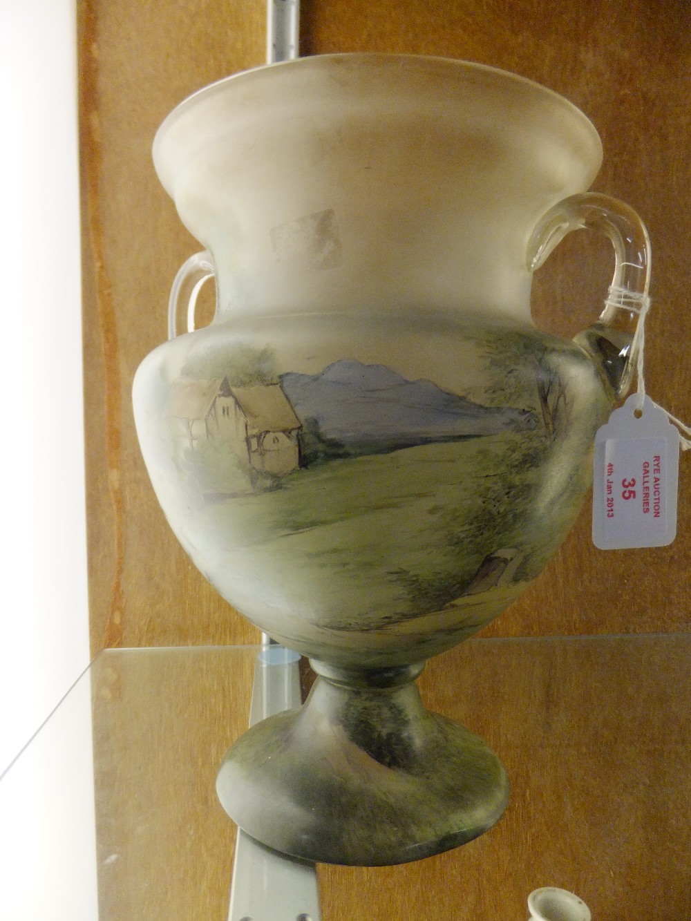 A late 19th century Bohemian amphora shaped vase with pictorial scene depicting the return from