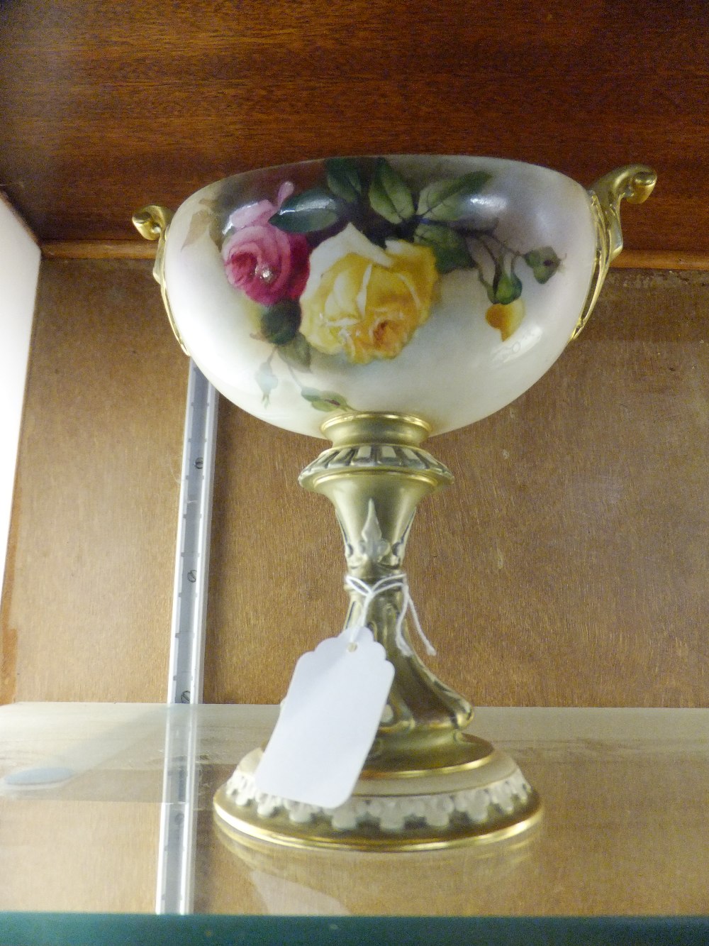 A Royal Worcester hand painted chalice with floral decoration and gilt base (restored)