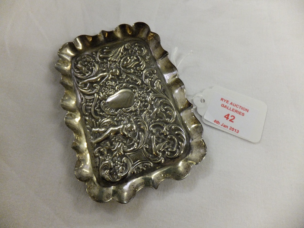 A London 1897 silver pin tray embossed with putti, birds, hare and squirrel, with central blank