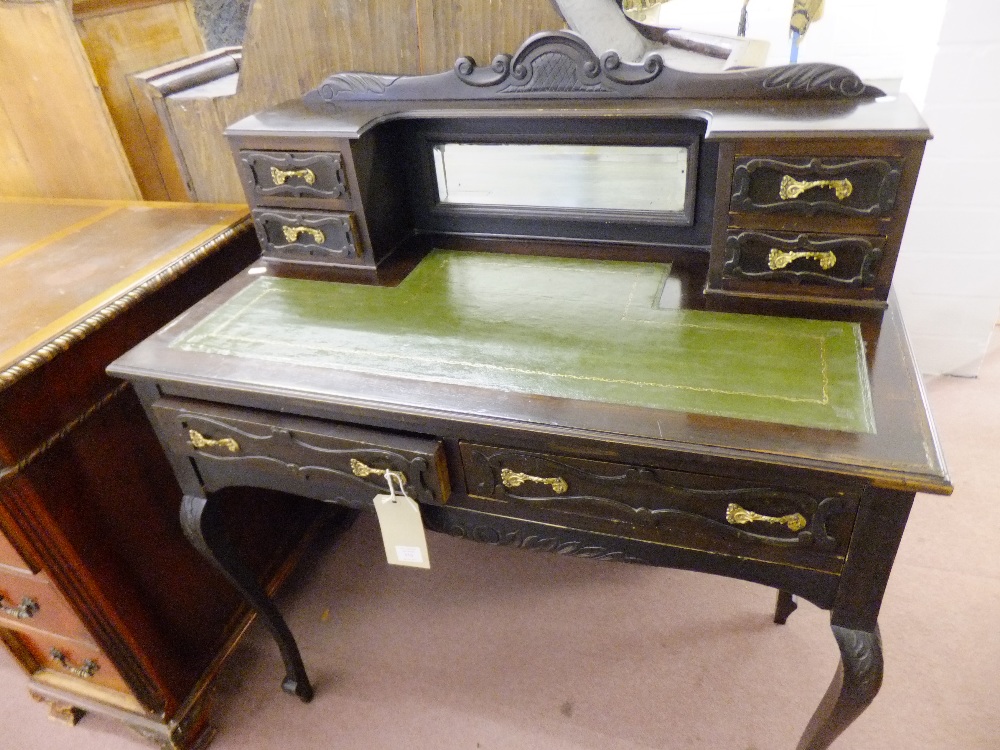 A stained mahogany ladies writing desk the top having mirrored back flanked by four short drawers