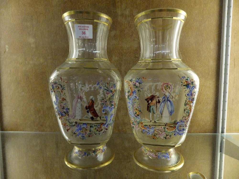 A pair of Bohemian circa 1860/80's baluster shaped vases with facet cut necks having hand-painted