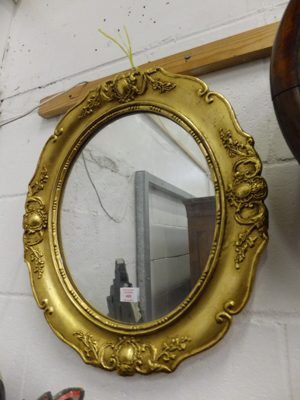 A early 20th century gilt wood framed mirror with floral and cartouche decoration 52 x 45cm. This is