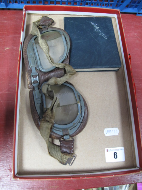 A Pair of WWII Flying Goggles, glass appears unbroken. Plus an autograph and sketch book from the