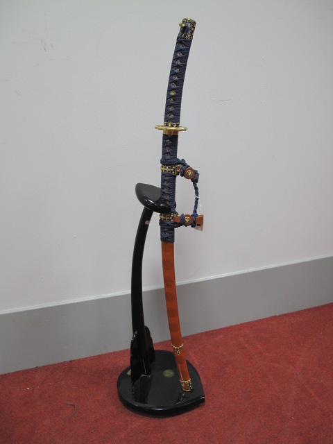 A Modern Replica of a Samurai Sword, finished in blue and gold, complete with stand.