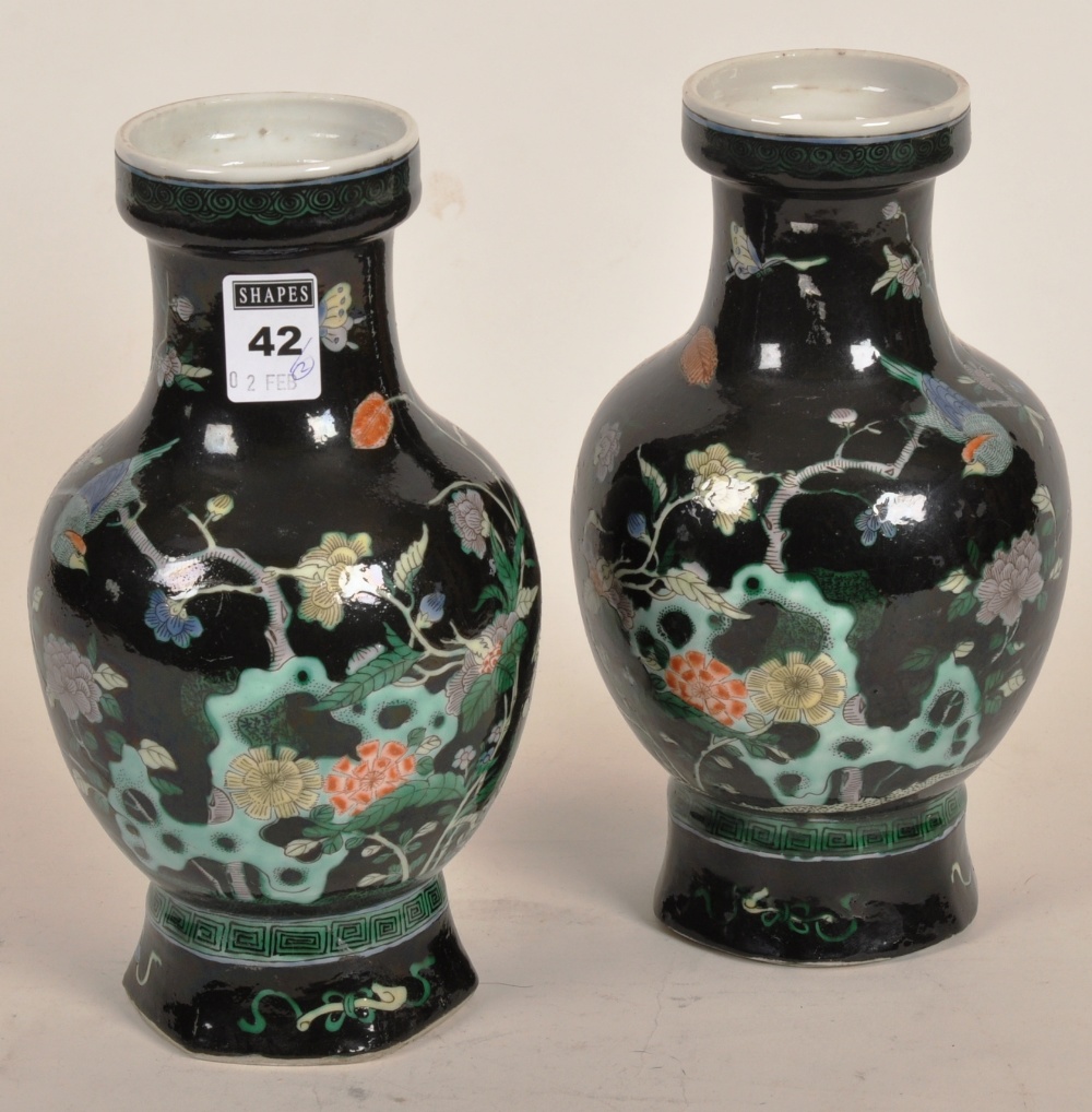 A pair of Chinese Famille Noire vases with blossom and foliage in coloured enamels, 22cm high (2)