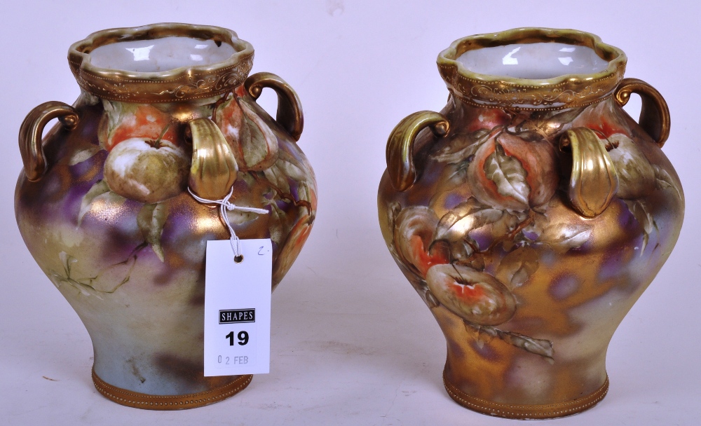 Pair of Noritake twin handled porcelain vases, each hand painted with fruits and foliage against a