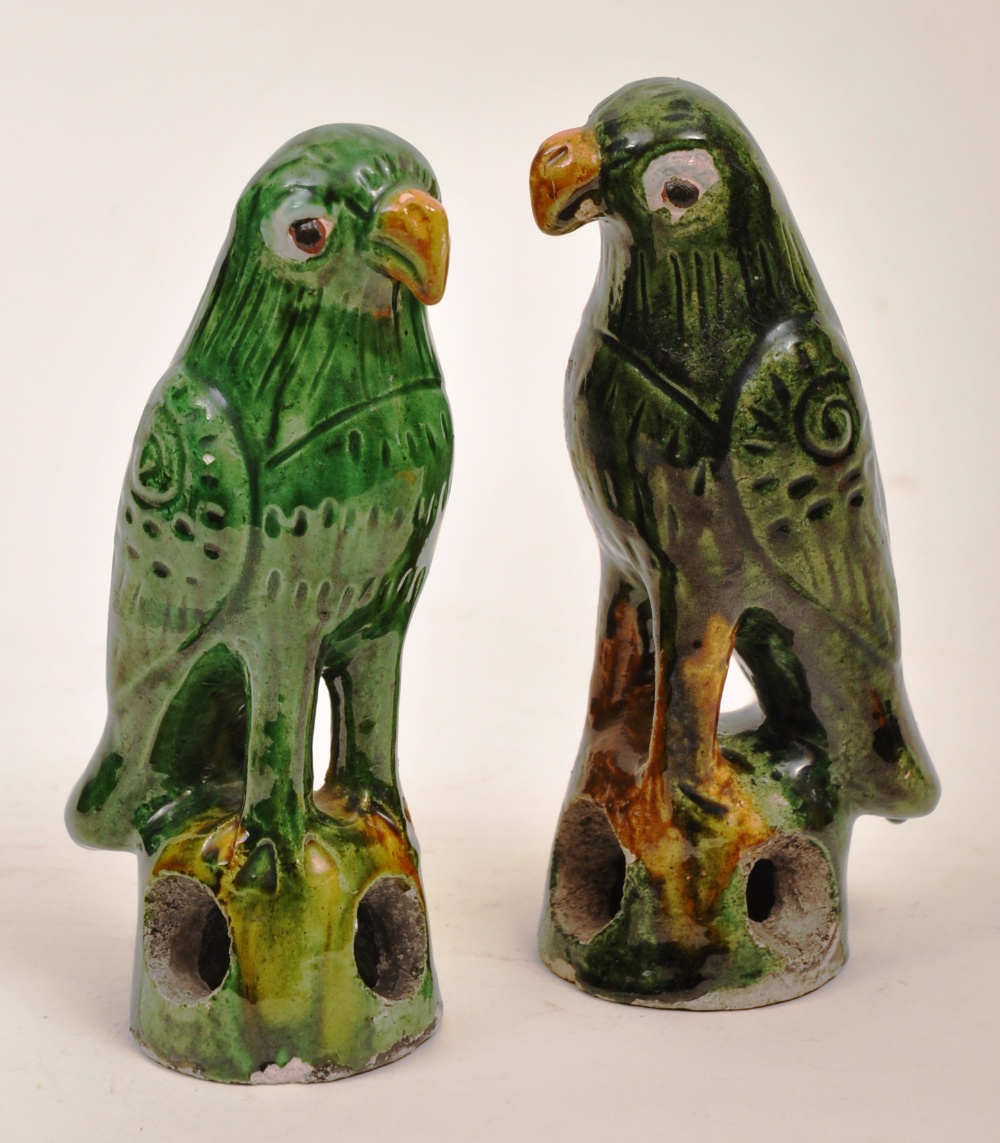 A pair of Chinese green glazed stoneware parrots, 16cm high