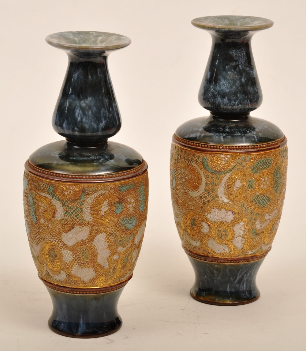 A pair of Royal Doulton `Slater`s Patent` stoneware vases, the blue glazed vases with central