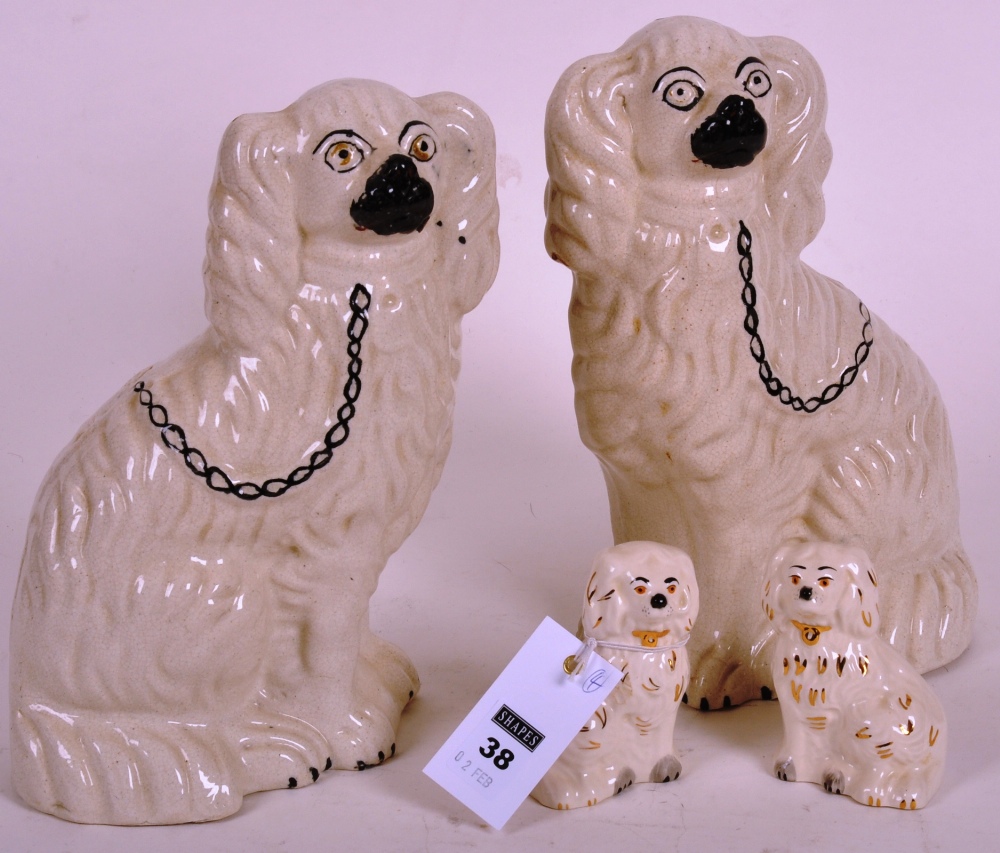 Pair of Staffordshire chimney spaniels and a pair of Beswick miniature spaniels (4)