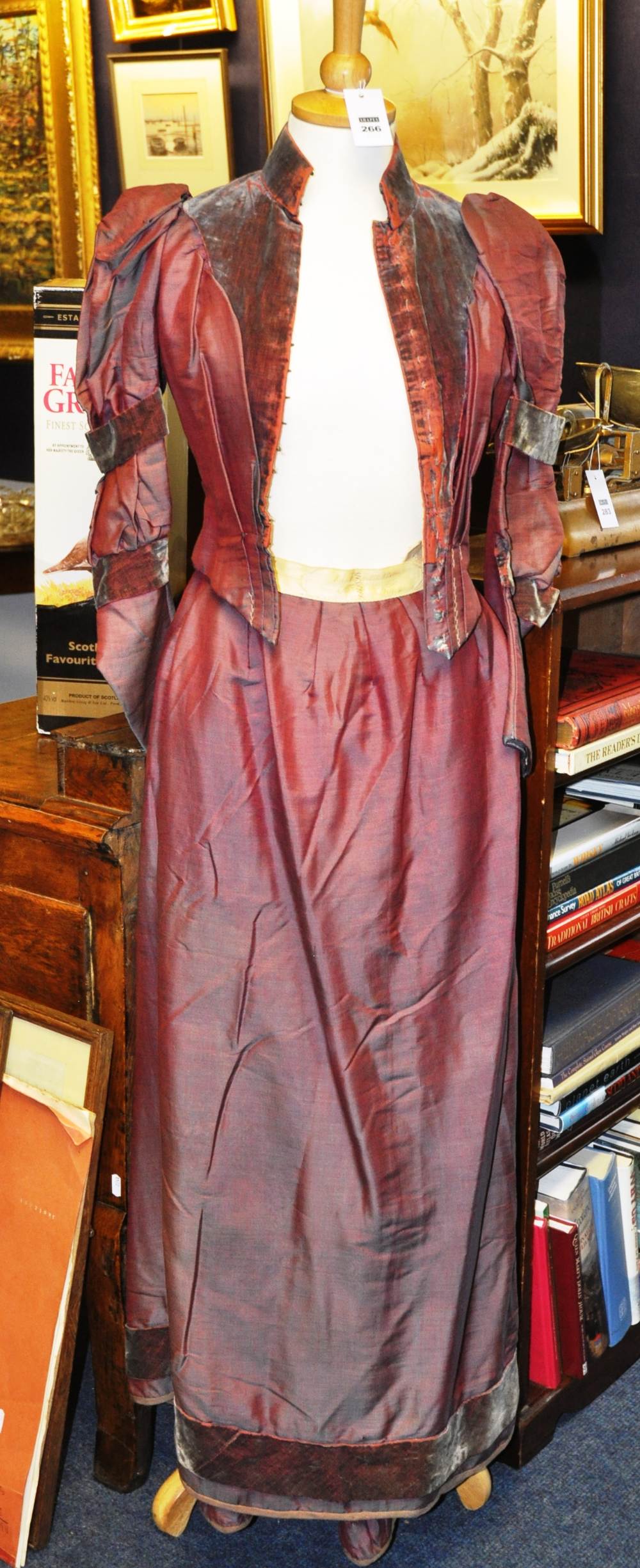 An Edwardian shot silk and velvet fitted jacket and matched long skirt in aubergine