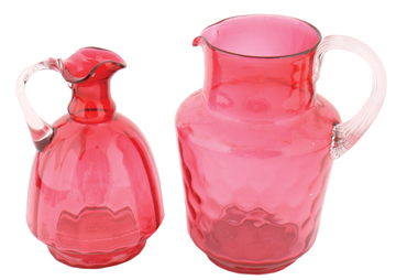 Two nineteenth century cranberry glass jugs 19.5 cm. and lower