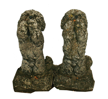 Pair of early twentieth-century reconstituted stone poodles, each seated on its hind legs