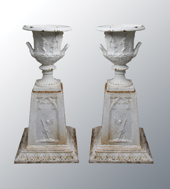 Pair of nineteenth-century cast iron jardinieres, the frieze and base with raised figural decoration