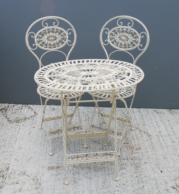 Cast iron patio table and two chairs