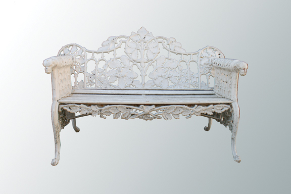 Pair of ornate cast iron garden seats, raised on scroll ends