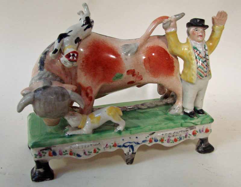 After William Kent, a Staffordshire Pottery group, Bull Beating Now Captain Lad, on a base, sponge