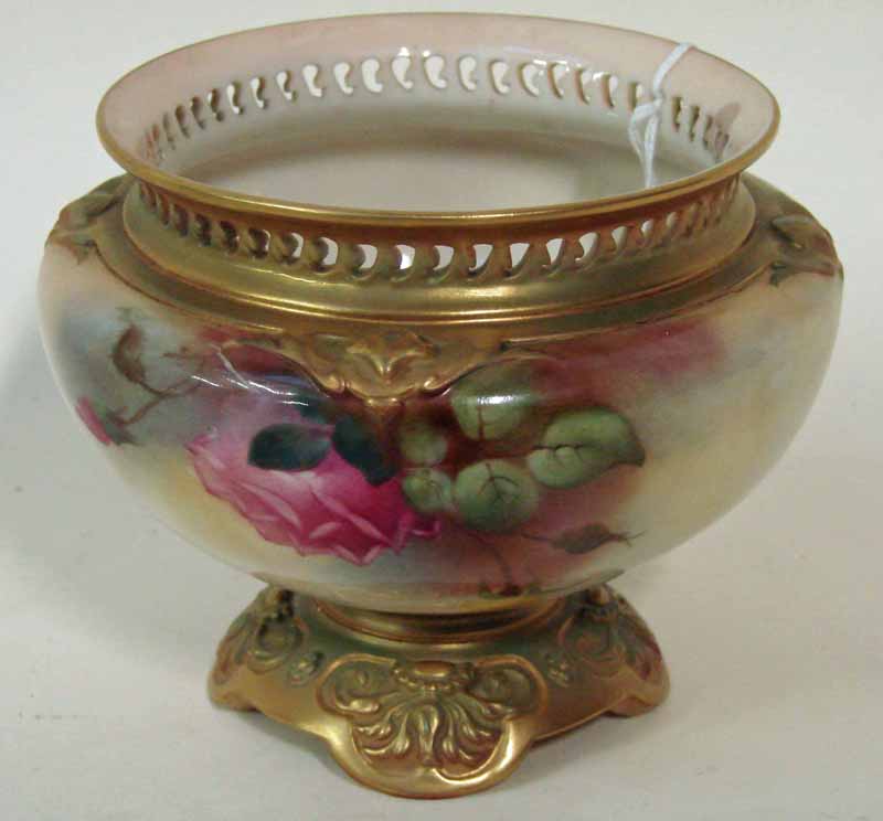 A Royal Worcester porcelain vase of flattened circular form with pierced everted rim on shaped