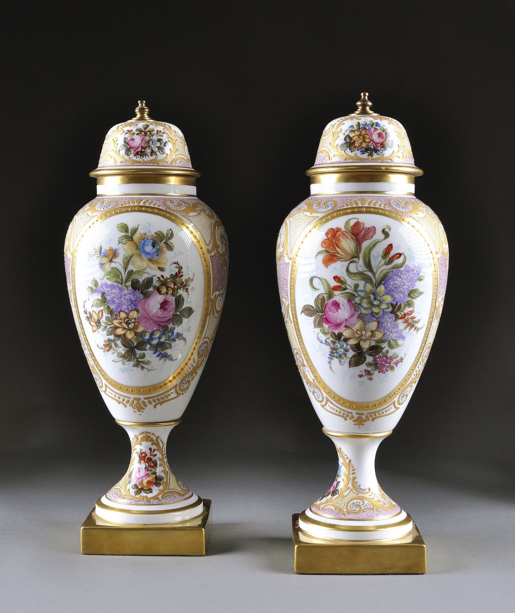 A PAIR OF SÈVRES STYLE PARCEL GILT AND COLORFULLY PAINTED VASES AND COVERS, BY LIMOGES, 20TH