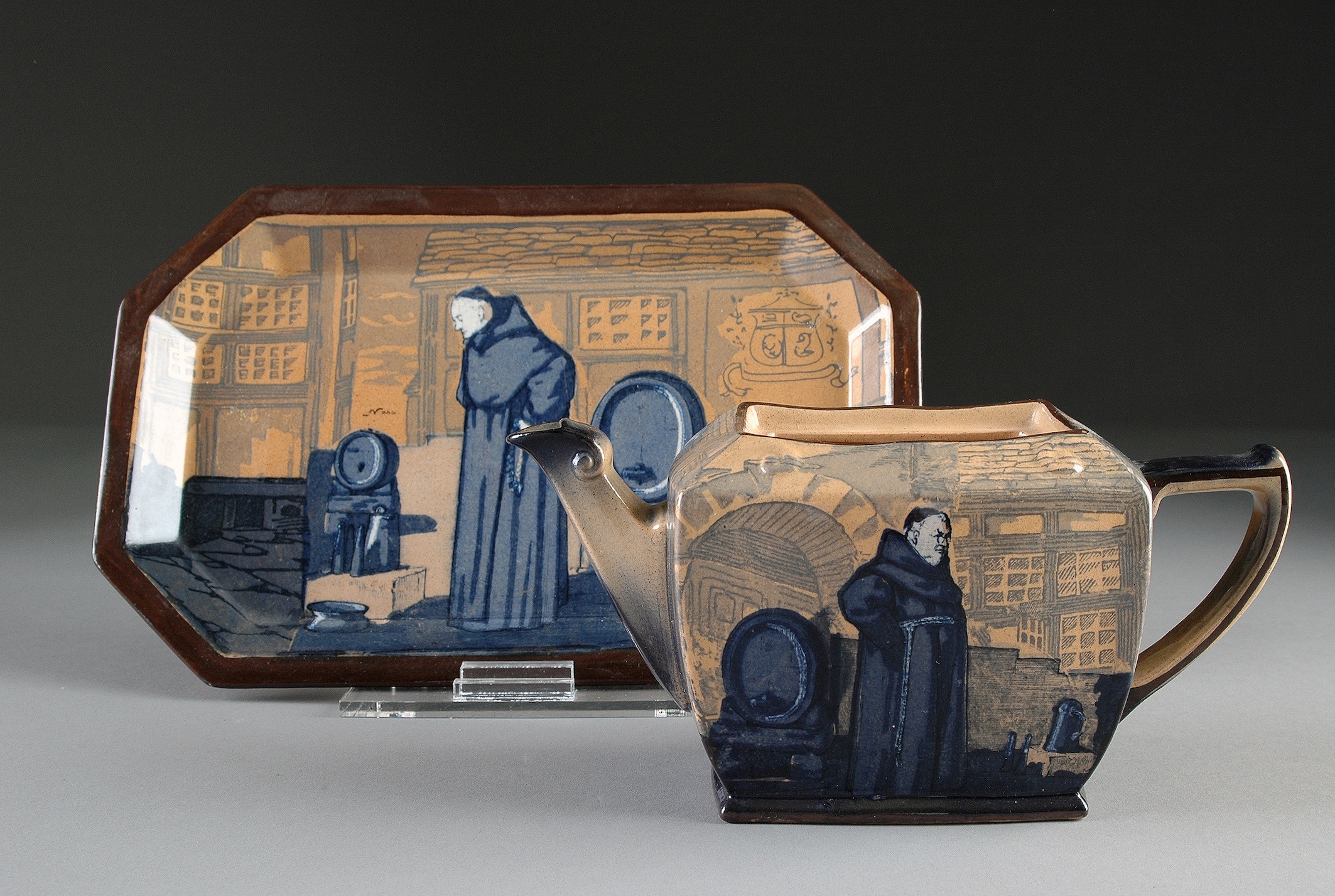 ROYAL DOULTON TEAPOT AND UNDERPLATE, IN THE “MONKS IN THE CELLAR” PATTERN, series designed and