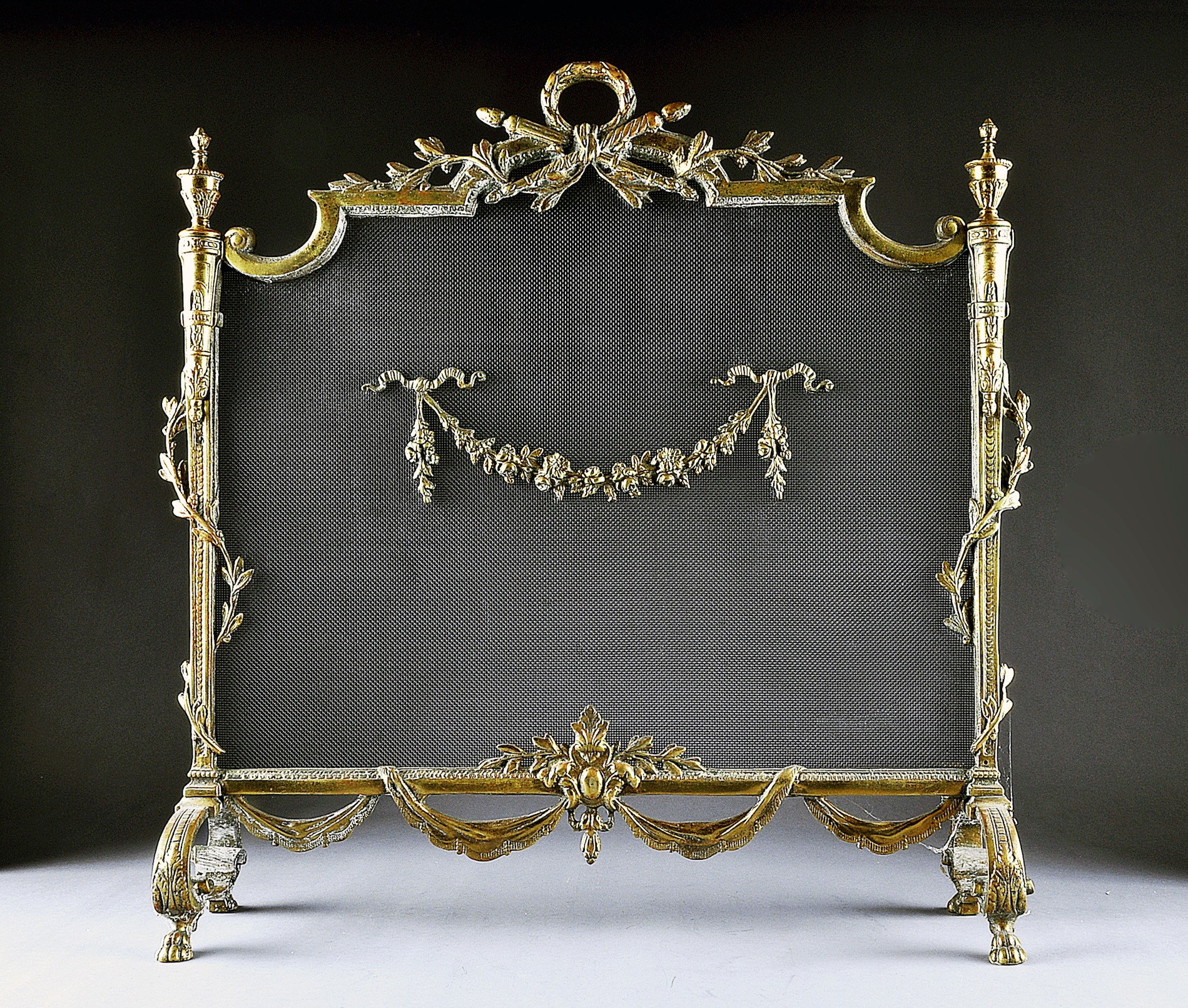 A LOUIS XVI STYLE GILT BRONZE FIREPLACE SCREEN, EARLY 20TH CENTURY, the rectangular wire mesh screen