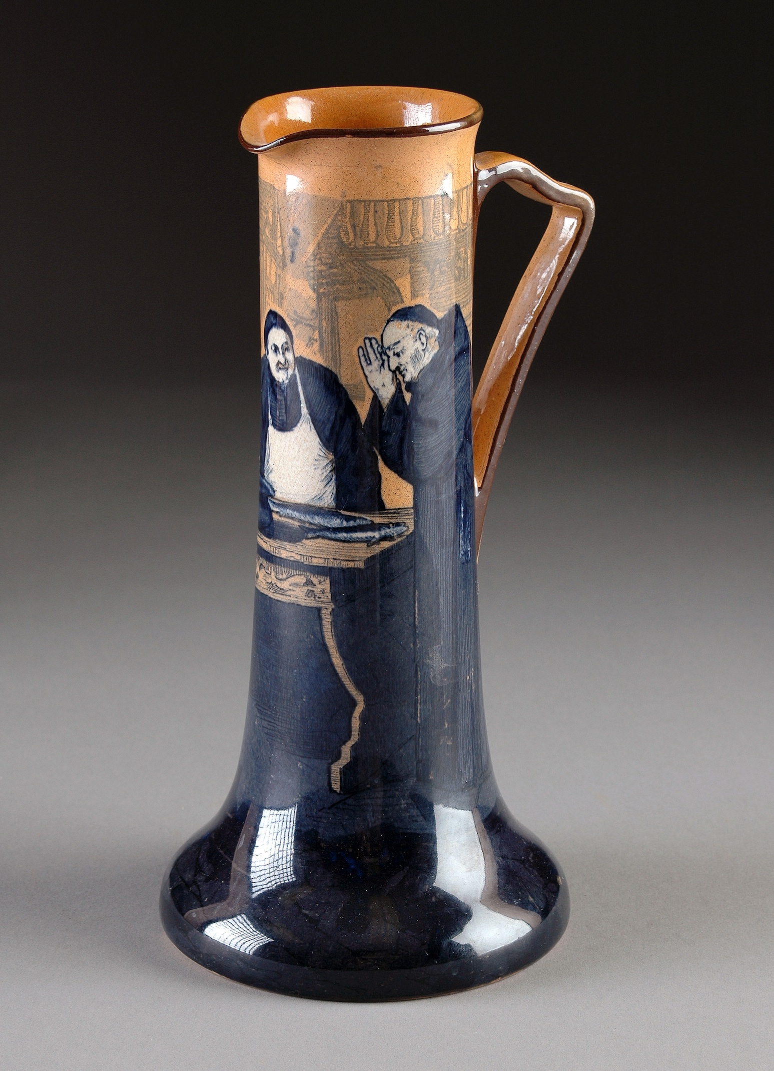 A ROYAL DOULTON PITCHER IN THE "MONKS IN THE CELLAR" PATTERN series designed and signed by Charles