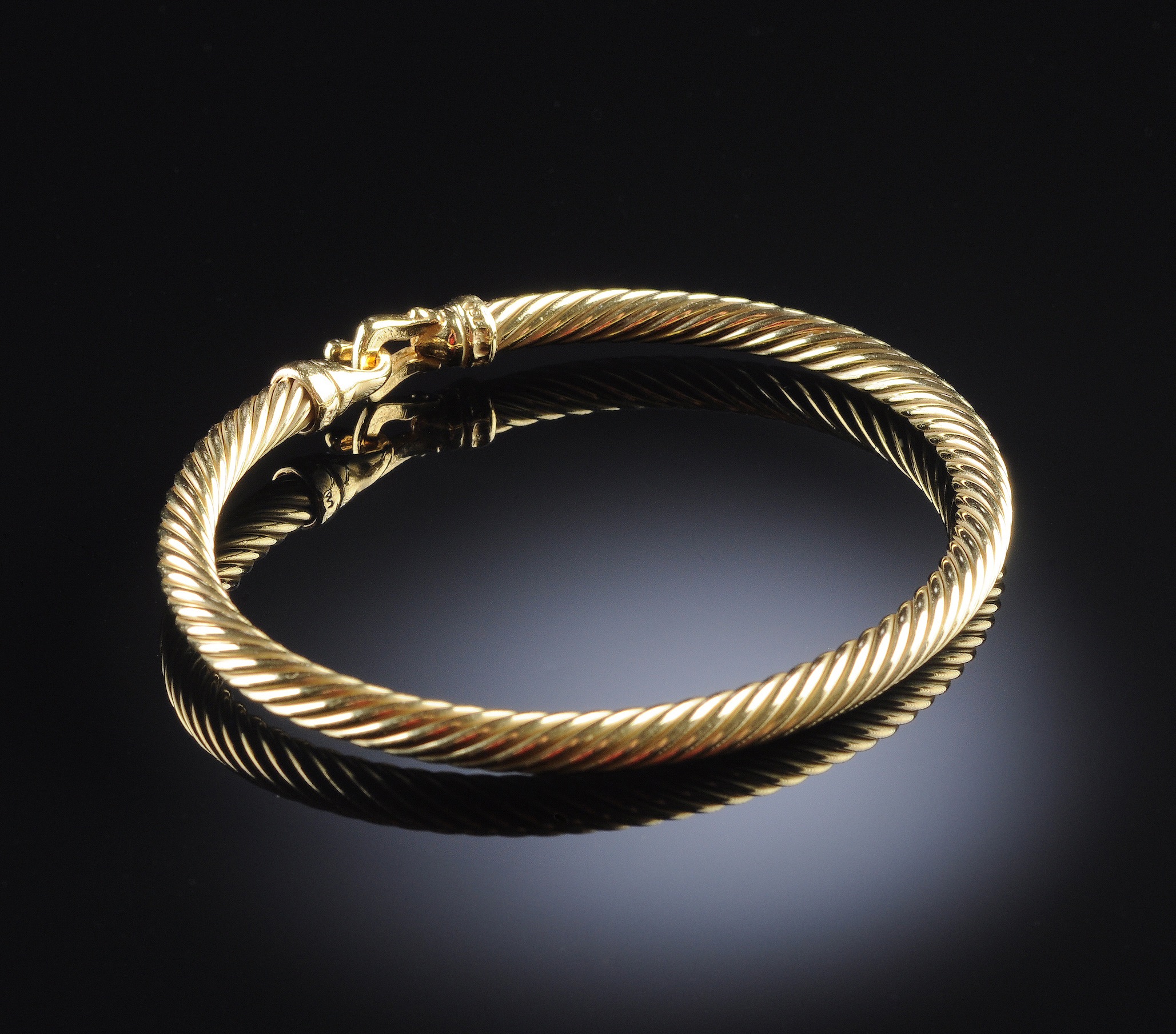 AN 18K DAVID YURMAN LADY`S CABLE BRACELET, the yellow gold band measuring 4 millimeters in