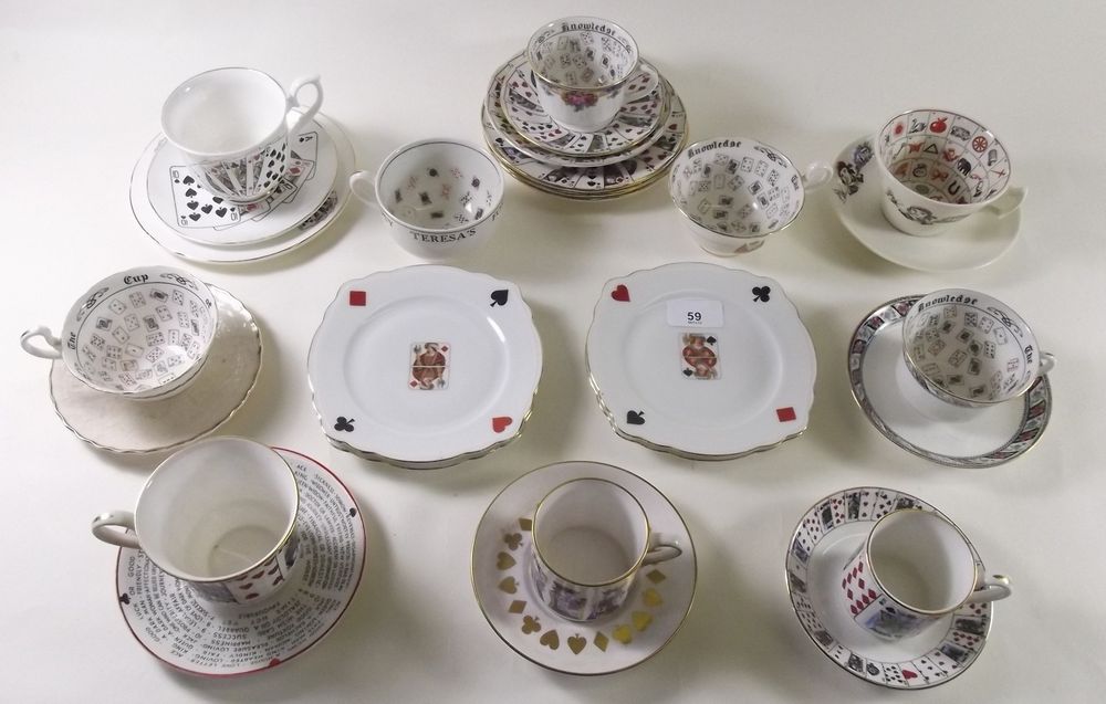 A group of fortune telling and playing card related cups and saucers and tea plates