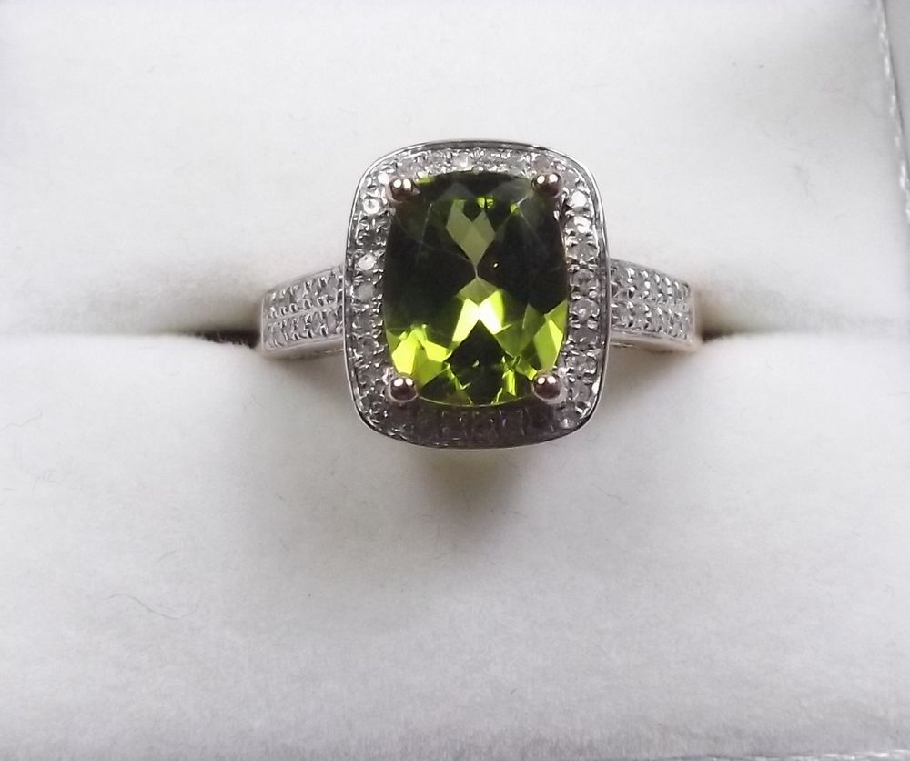 A 14k rose gold and diamond ring set with a cushion cut peridot approx 3.20 carats