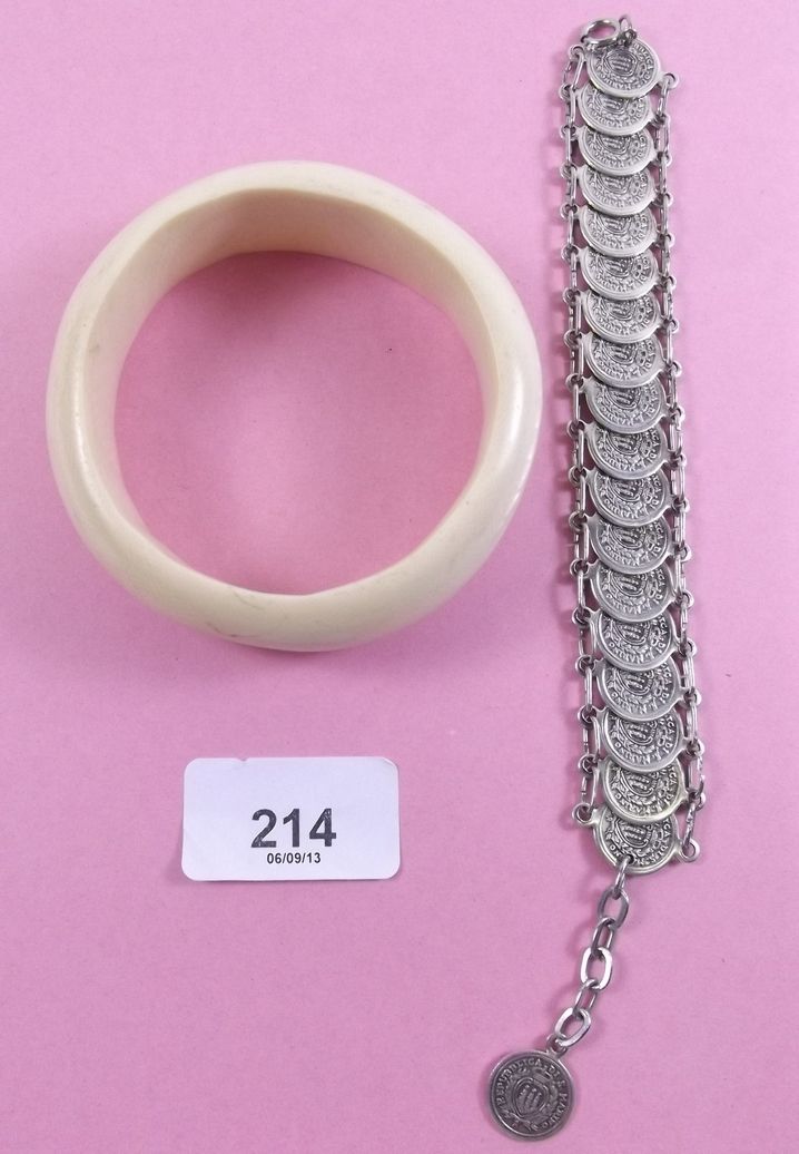 An ivory bangle and a coin bracelet