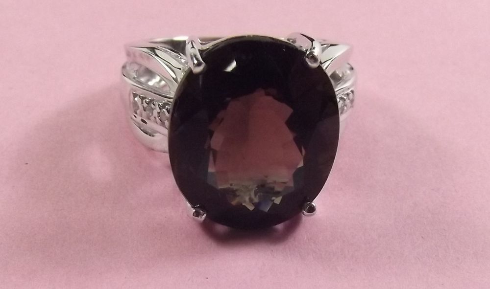 An oval cut smoky quartz and white sapphire sterling silver ring