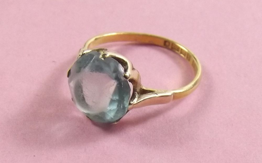 A 22 carat gold ring set blue stone