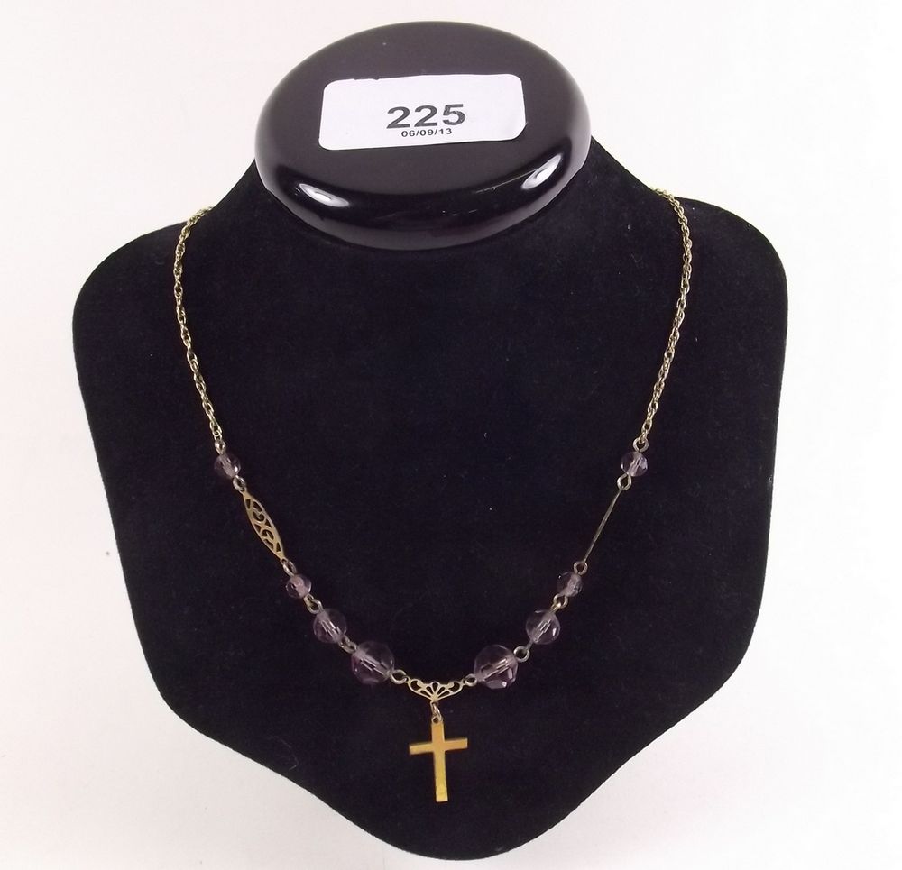 An Edwardian cross on later gold chain with beads