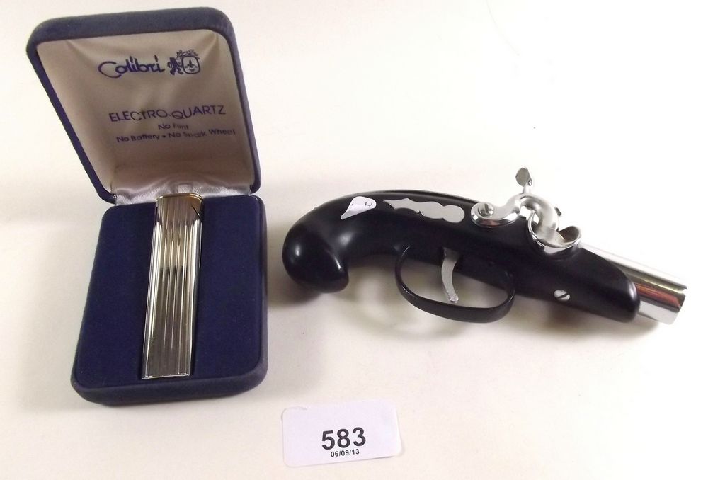 A Colibri lighter - boxed and a novelty gun lighter