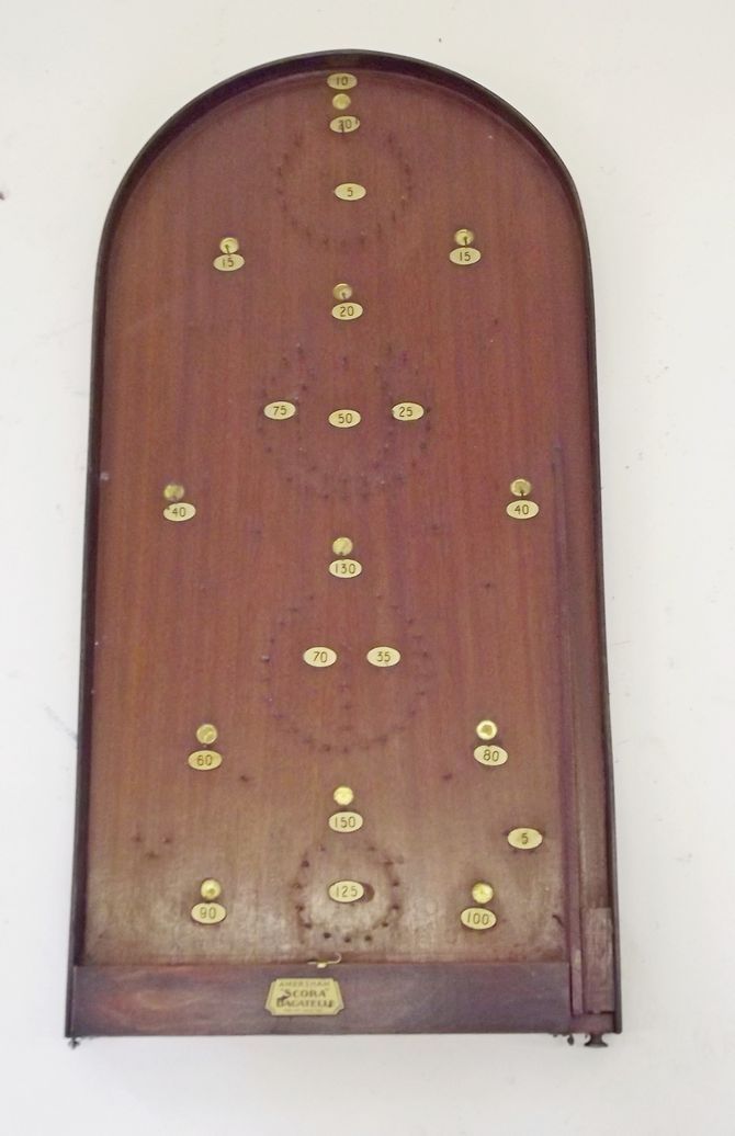 An Amersham `Scora` bagatelle board with scorer and twenty steel balls