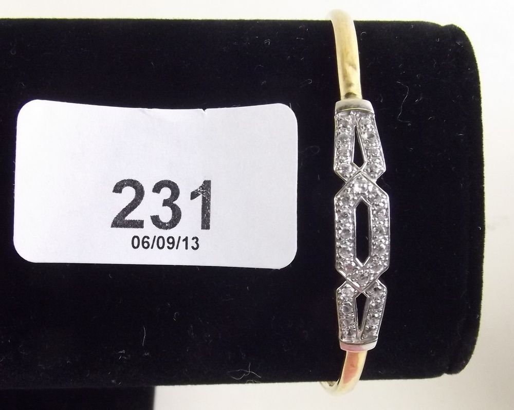 A 9 k bangle set openwork panel of small diamonds