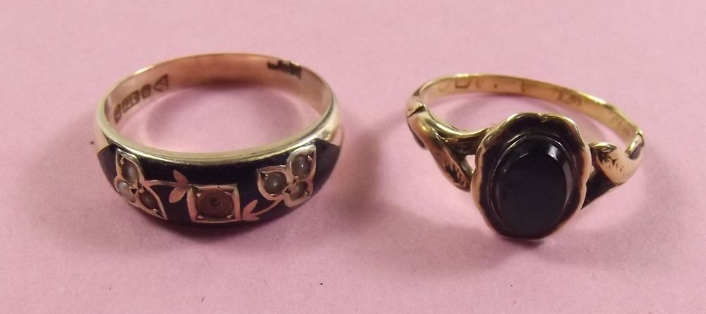 Two Victorian gold black enamel mourning rings, one inscribed to interior and dated 1854